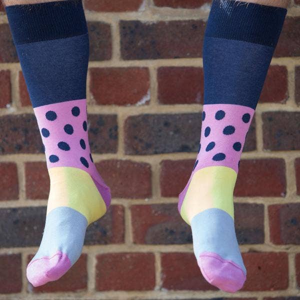 These are the men's Mayfair socks in navy, and they're very stunning. The brightly coloured socks would look great with any of his ensembles. Luxury men's socks in a timeless design with a modern twist, featuring a solid navy cuff with pink and navy polka dots and a gorgeous yellow and grey sole.