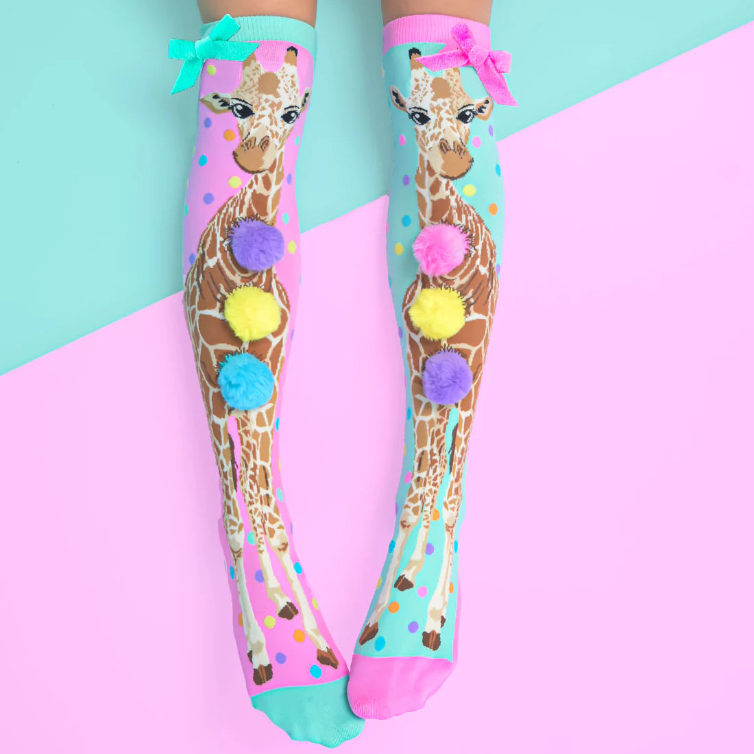 The prettiest pair of Giraffe socks you will ever see are our brand-new MADMIA Giraffe socks, which are now available. Everywhere you go, they make a big impact thanks to custom-made Pom Poms and a pink and blue bow attached to the side.